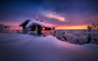 snow cabin in the evening sunset