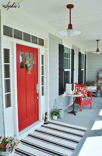 Farmhouse with a Red Door and Black Shutters
