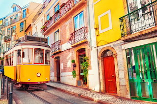 Trolley with colorful houses lisbon portugal
